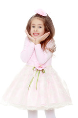 Elegant little girl in a pink dress.