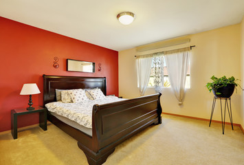 Chic master suite with red accent wall