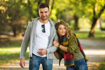 Fototapeta premium Beautiful couple on a walk in autumn forest