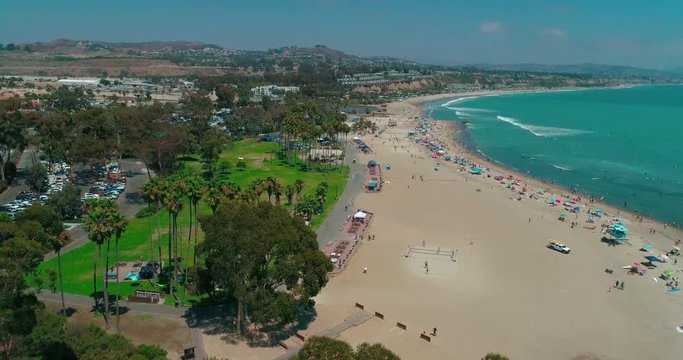 DANA POINT, California. Doheny State Beach. A sunny day beach scene with people engaged in beach activities. Surfers. Aeria 4K