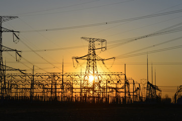 The silhouette of the evening electricity transmission pylon