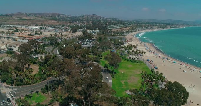 DANA POINT, California. Doheny State Beach. A sunny day beach scene with people engaged in beach activities. Surfers. Aeria 4K
