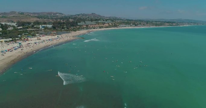 DANA POINT, California. Doheny State Beach. A sunny day beach scene with people engaged in beach activities. Surfers. Aeria 4K