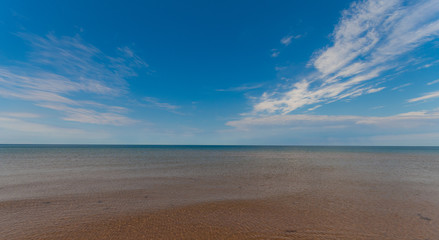 Fototapeta na wymiar View of the horizon on a warm sand beach in a sunny day at Prince Edward Island Canada