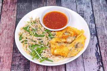 Thai food,Fried egg and oyster with bean sprouts and shallot as Hoi Tod Khai in Thai served