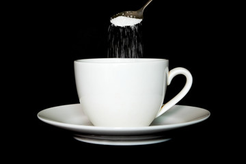 Pour Sugar in coffee cup .black backgruond