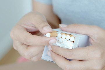 Woman's hand She was picking up a cigarette from a cigarette pack.