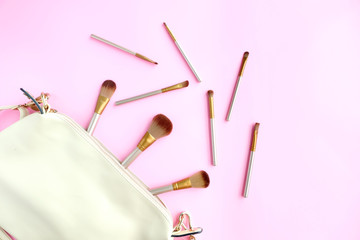 Women's cosmetics bag brush make up  on pink background