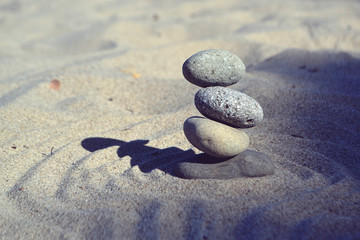 Fototapeta na wymiar Balanced rocks in zen garden sand circles