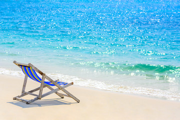 A seat on the beach with blue sea background