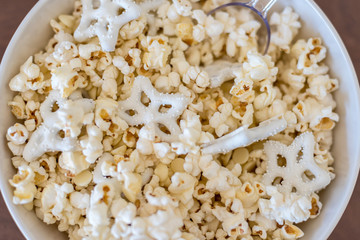 overhead closeup of popcorn and pretzels in bowl in wnter