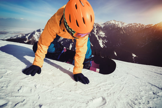 snowboarder snowboarding on winter mountain top slope