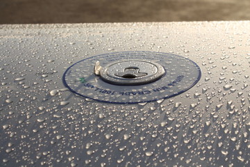 Fototapeta na wymiar aircraft wing fuel cap water droplets