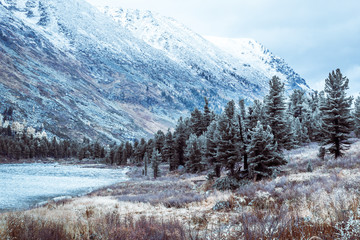 Beautiful view of the mountain range with snow-capped peaks. Landscape of mountain valleys and cliffs.