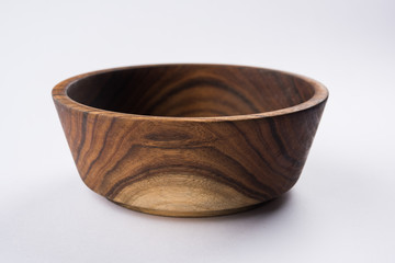 Empty wooden bowl or decorative wooden plate, isolated over white background   © StockImageFactory