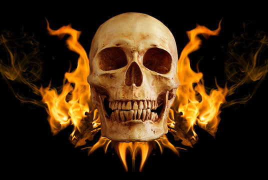 Skull on black cloth and black background.Skull in flame on black backgroundSkull in flame on black background / art image