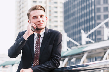 Handsome businessman using his smartphone