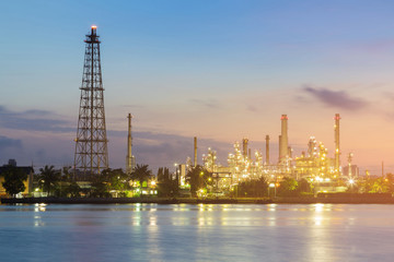 Night light over petroleum refinery factory river front, industrial background