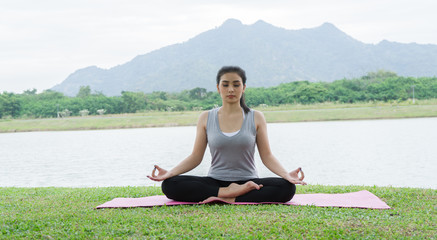 Naklejka na ściany i meble Young woman meditates while practicing yoga. Freedom concept. Calmness and relax, woman happiness. Toned picture