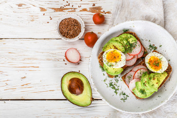 Toast with avocado, radish, egg and flax seeds