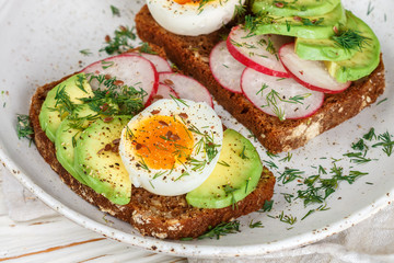 Toast with avocado, radish, egg and flax seeds