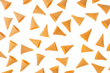 Funny corn snack in the shape of horn as pattern isolated on white background. Top view.