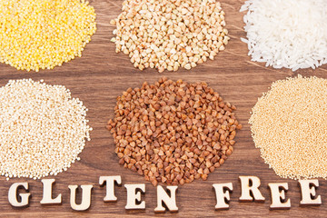 Gluten free inscription, rice and groats on rustic board, healthy nutrition