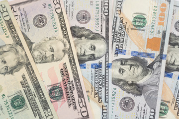 Pile of various US american dollar money bills spread on table.