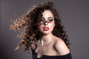 Fototapeta premium Beautiful teen girl on a gray background