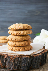 Stack of oatmeal cookies on a wooden background      