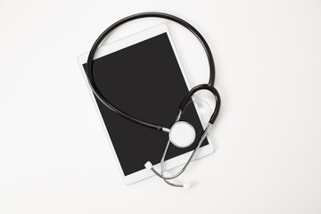 Digital Tablet And Stethoscope On White Table