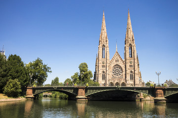 Fototapeta na wymiar St. Paul's Church, a major Gothic Revival Lutehran church and one of the landmarks of the city of Strasbourg, in Alsace, France, with the River Ill