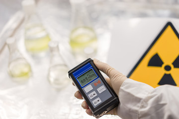 the scientist measures the level of radioactive radiation from the samples