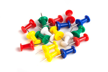 Closeup of Many Colored Thumbtacks on White