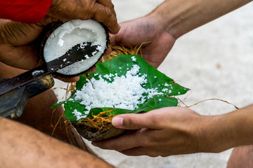 Travel and holiday photos on an island near Tahiti. Cultural show demonstrating how to open a coconut. Coconut demonstration.