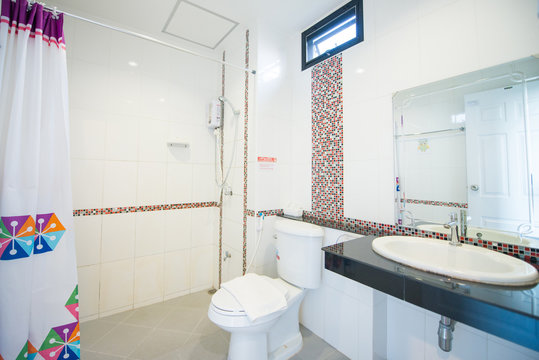 Interior of the bathroom with white toilet and basin