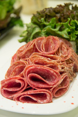 Meat sausage, salame on white