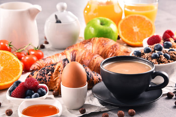Breakfast served with coffee, juice, croissants and fruits