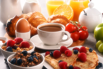 Breakfast served with coffee, juice, croissants and fruits