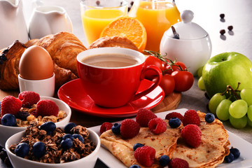 Breakfast served with coffee, juice, croissants and fruits