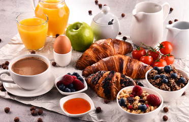 Breakfast served with coffee, juice, croissants and fruits
