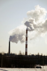 The smoke from the chimneys. Air emissions from the industrial pipe against the sky.Ecology.