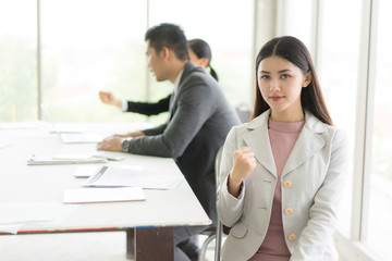 Modern business woman in the office with copy space.she sit down and smile.