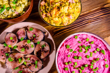 Different festive dishes on a wooden table. Top view