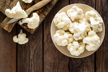 Fresh cauliflower on wooden board. Raw cauliflower. Top view