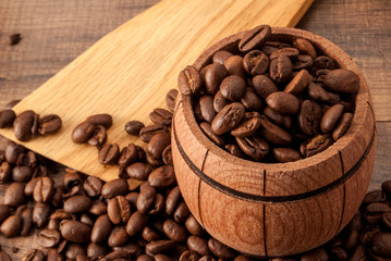a barrel and coffee on a wooden surface and a wooden spoon