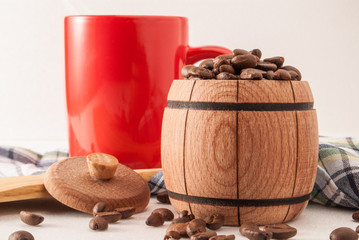 A barrel and coffee on a gray background and a red cup
