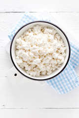 Cottage cheese, curd on white wooden rustic table, top view