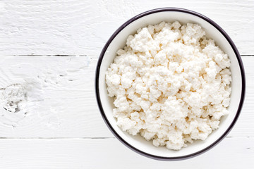 Cottage cheese, curd on white wooden rustic table, top view