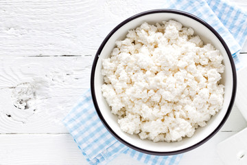 Cottage cheese, curd on white wooden rustic table, top view